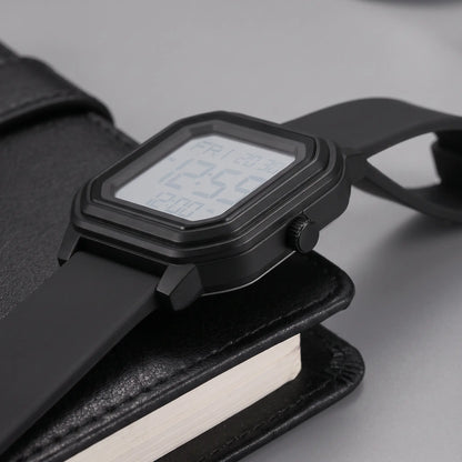 Side close-up of the black octagon digital watch showing the stepped bezel and side button