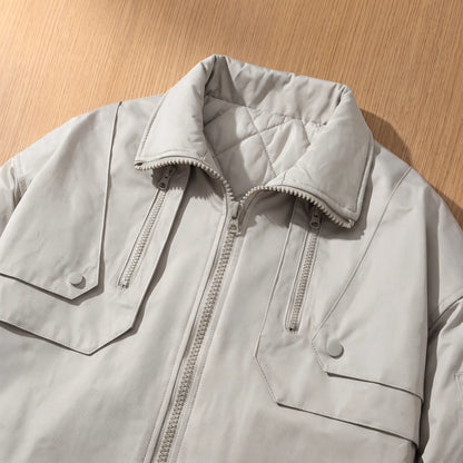 Close up of the PADDED COLLAR JACKET collar, chest zip pockets and snap flap