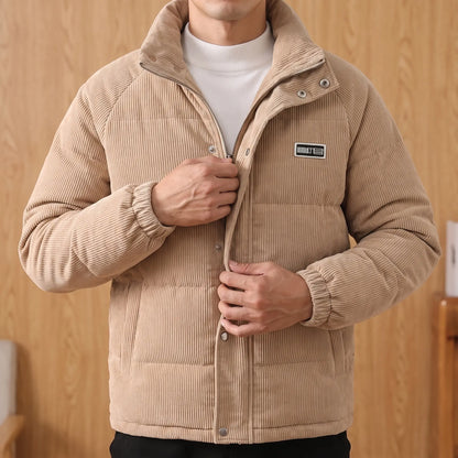 Man wearing the khaki padded corduroy puffer jacket and pulling the front zip closed