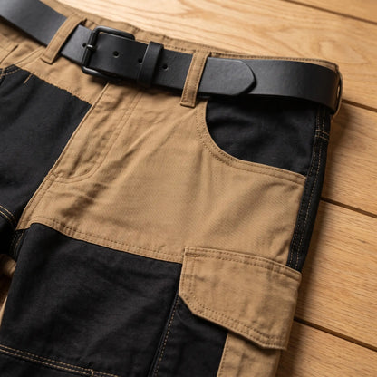 Close up of the waistband, belt loops, slant pocket and bellows cargo pocket on the tan panel cargo trousers