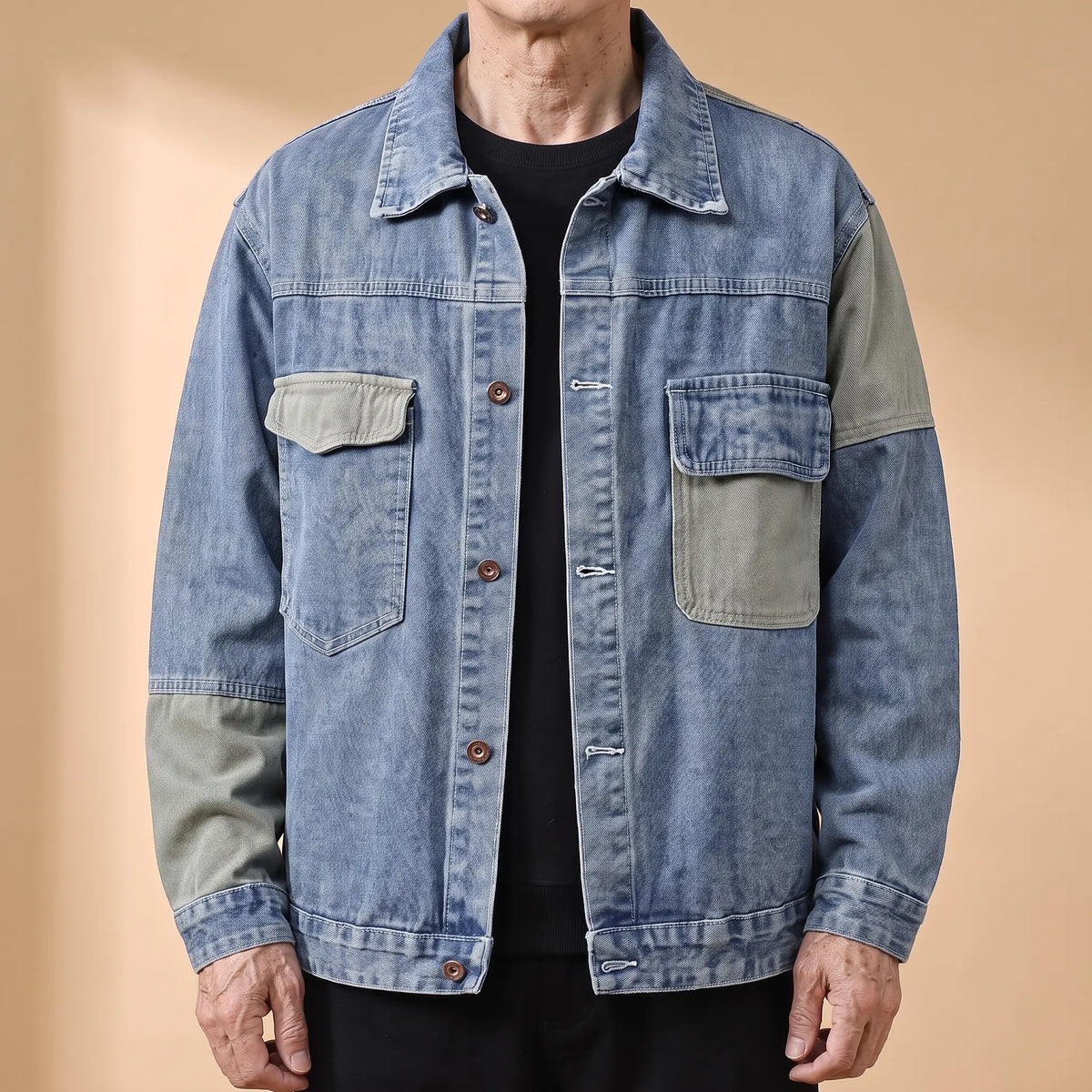 Blue panelled denim jacket with sage contrast panels worn open by an older man