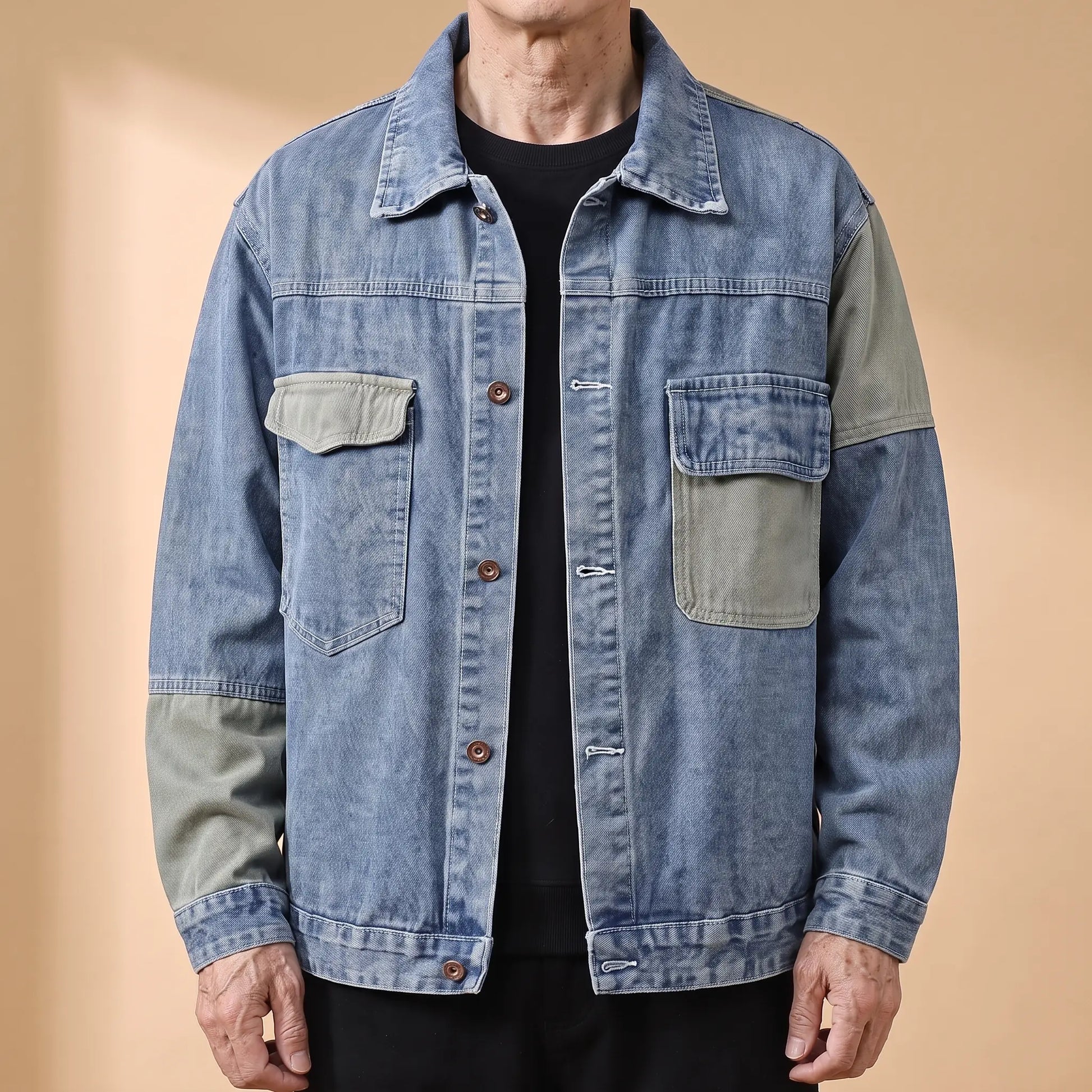 Blue panelled denim jacket with sage contrast panels worn open by an older man