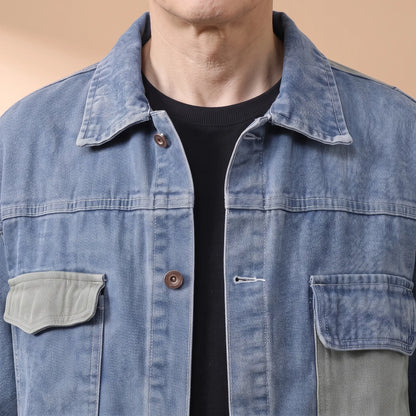Close-up of the denim jacket collar, copper shank buttons and sage flap chest pocket