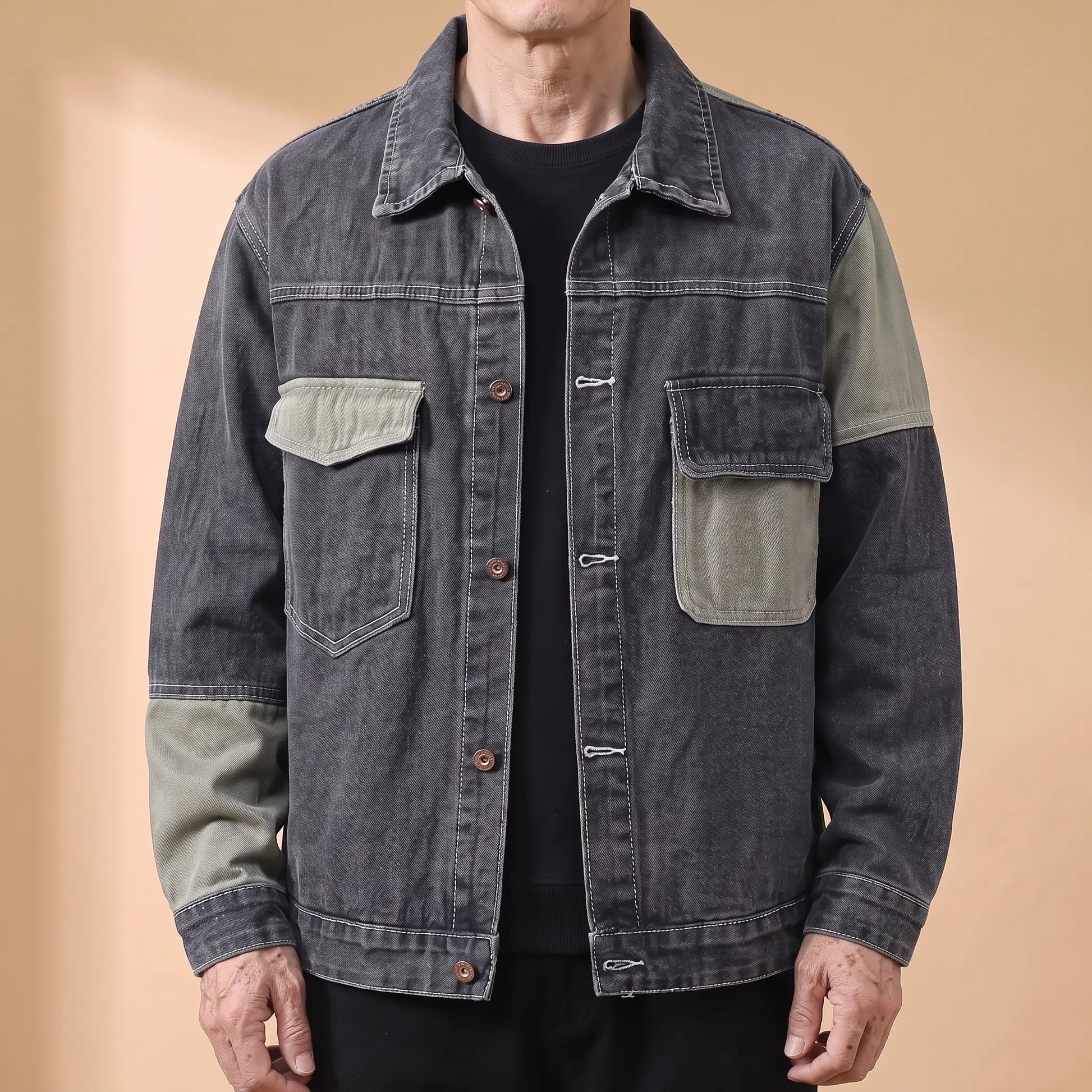 Grey panelled denim jacket with sage contrast panels worn open by an older man
