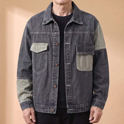 Grey panelled denim jacket with sage contrast panels worn open by an older man