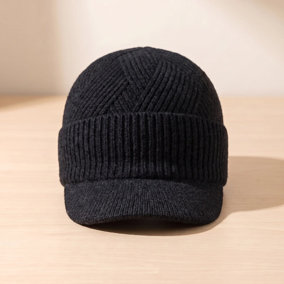 Men's black peaked knit beanie with chevron ribbed crown and folded cuff