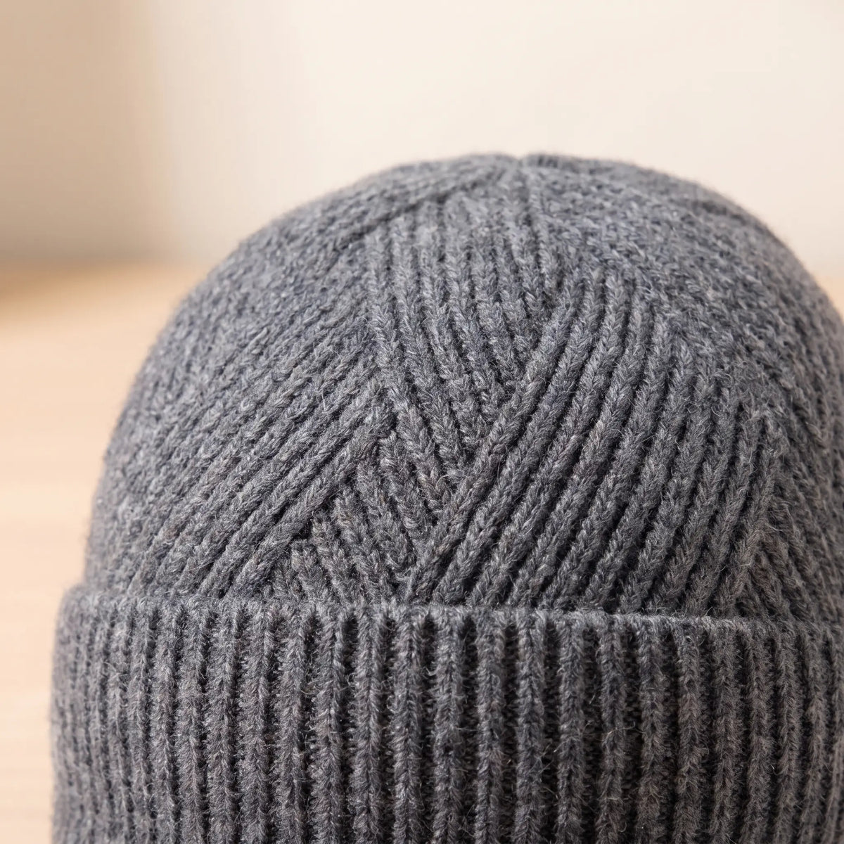 Close-up of grey peaked beanie chevron rib knit crown