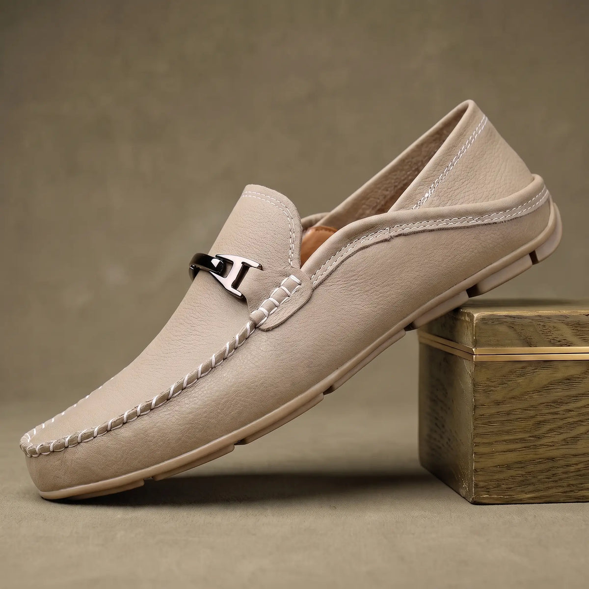 Beige pebbled leather slip on driving loafer for men with silver metal bar and ivory contrast stitching