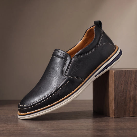 Men's black pebble grain slip-on loafer with moc toe stitching and white sole