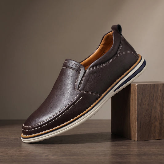 Men's brown pebble grain slip-on loafer with moc toe stitching and white sole