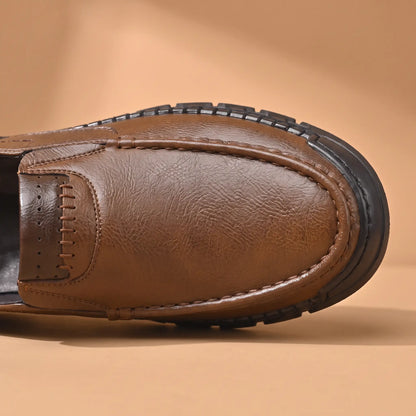 Pebble Moc Loafers in Brown, moc toe and cross-stitched collar band close-up
