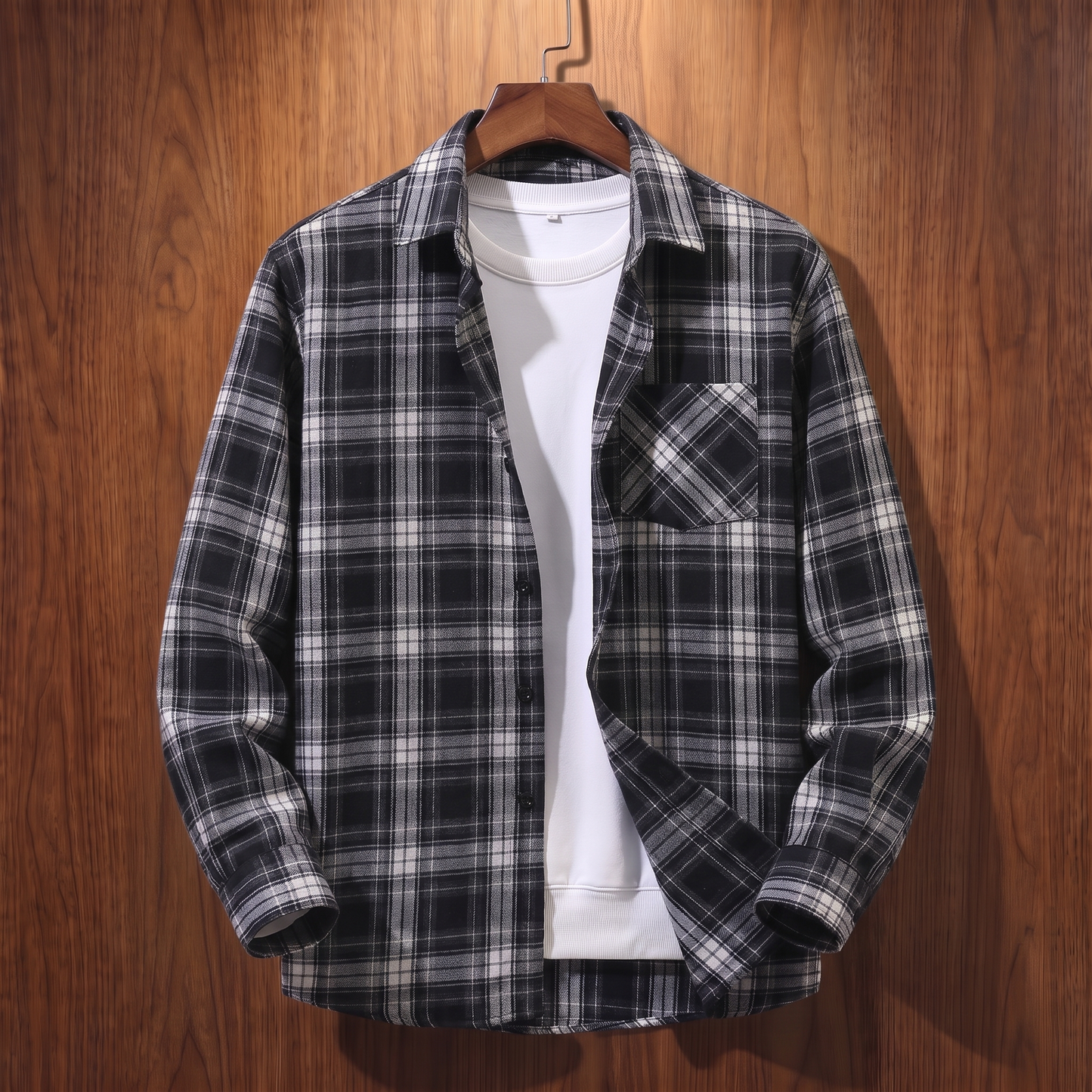 Black plaid flannel shacket on a wooden hanger