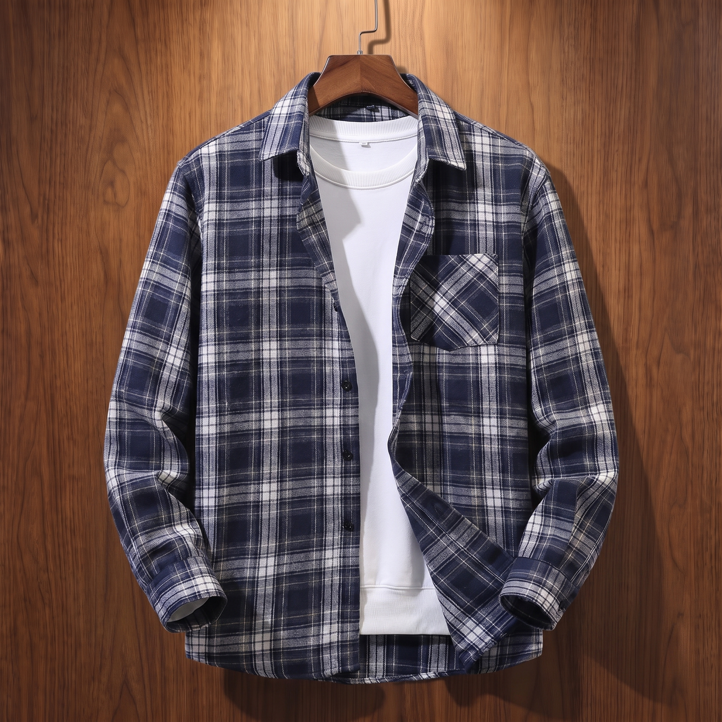 Navy plaid flannel shacket on a wooden hanger