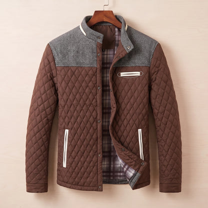 Brown diamond quilted jacket with tweed shoulder yoke on a wooden hanger