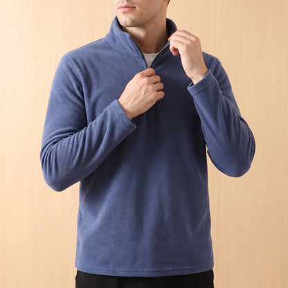 PLAIN FLEECE PULLOVER worn - man pulling the neck zip up at the collar of the navy fleece pullover