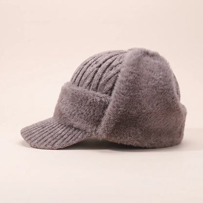 Men's khaki plush earflap beanie with cable knit crown, short knitted peak and fleece-lined ear flaps, side view