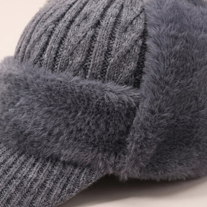 Close-up of grey earflap beanie cable knit crown meeting the soft plush band