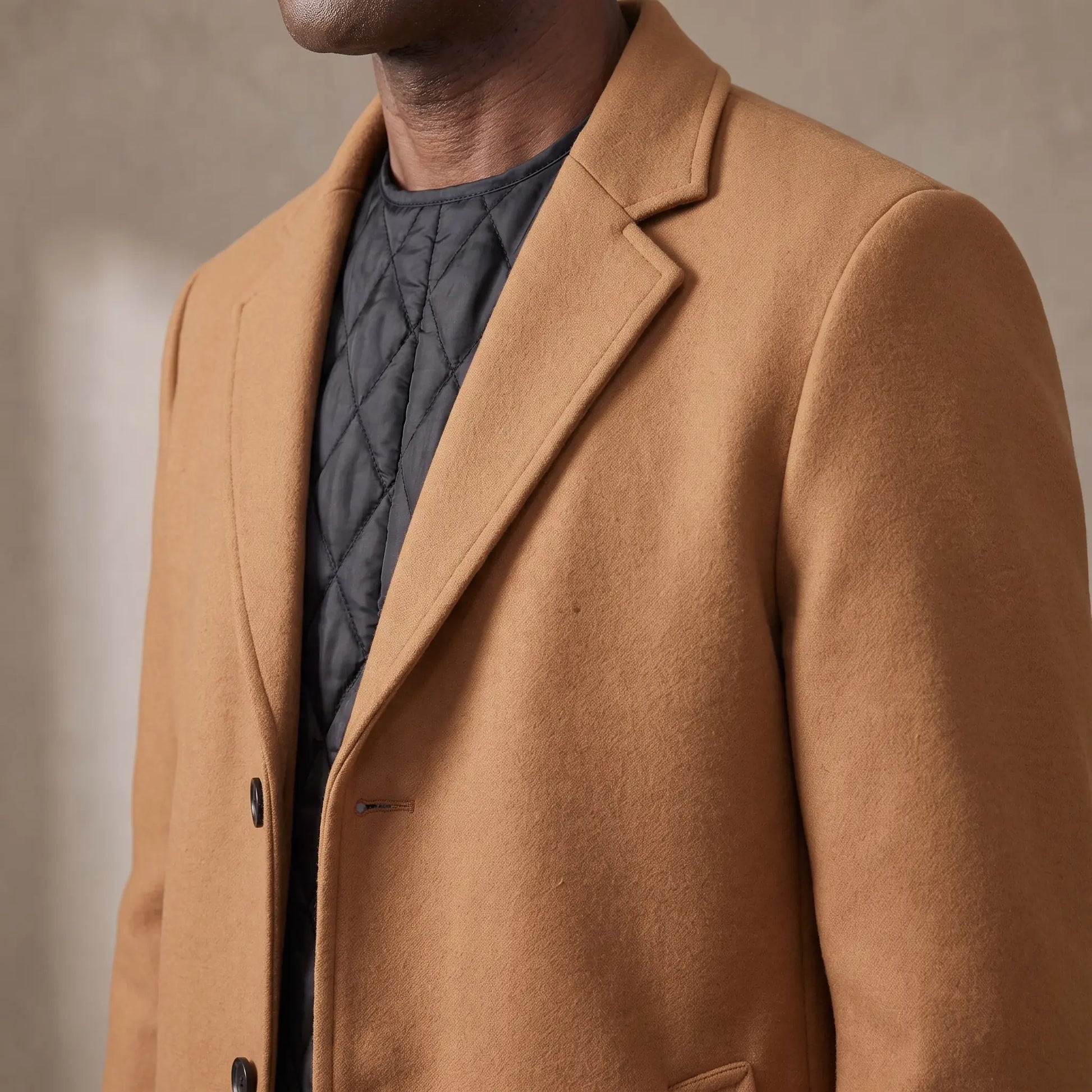 Close up of the notch lapel and quilted lining on the wool overcoat