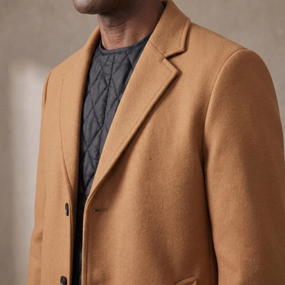 Close up of the notch lapel and quilted lining on the wool overcoat