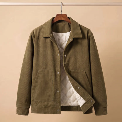 Army green quilted corduroy jacket on a wooden hanger showing the cream quilted lining