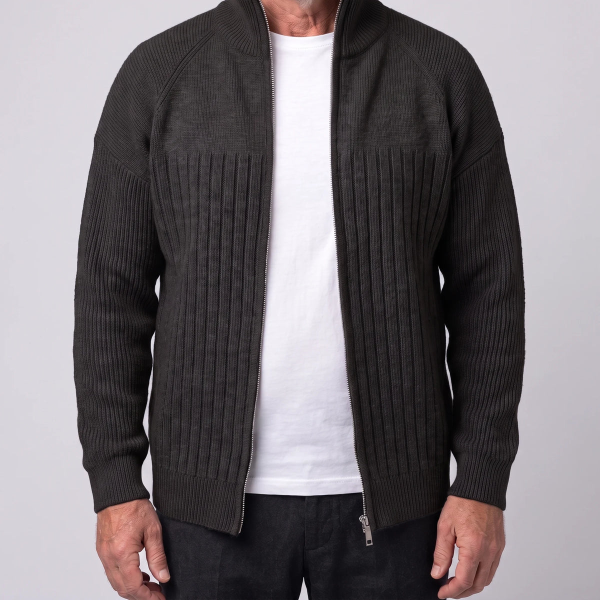 Black men's ribbed knit zip cardigan with tall stand collar and raglan sleeves, worn open