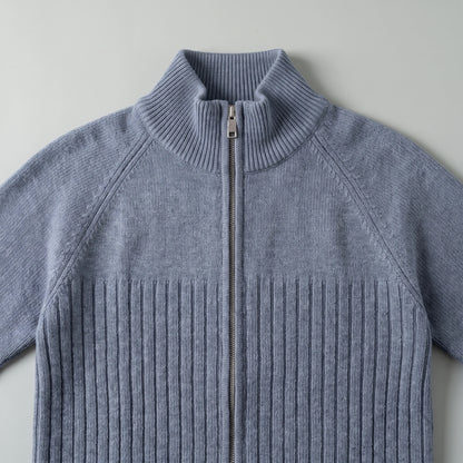 Close up of the tall stand collar, metal zip and ribbed chest of the raglan rib cardigan