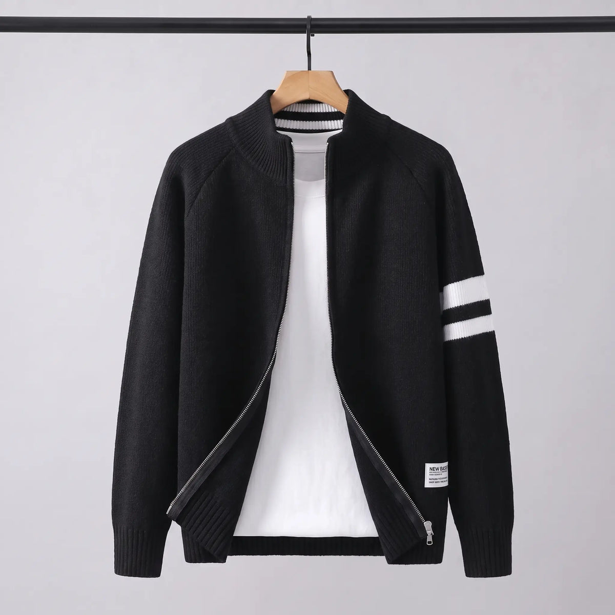 Raglan Zip Cardigan in black on a wooden hanger, men's knit full-zip cardigan with white sleeve stripes