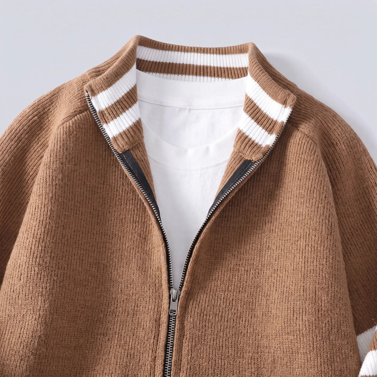 Close-up of the brown Raglan Zip Cardigan showing the striped stand collar and metal zip