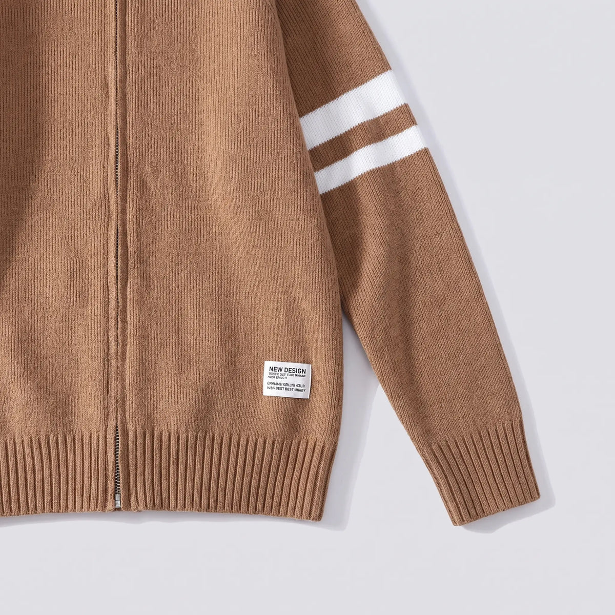Close-up of the brown Raglan Zip Cardigan showing the sleeve stripes, ribbed cuff and hem