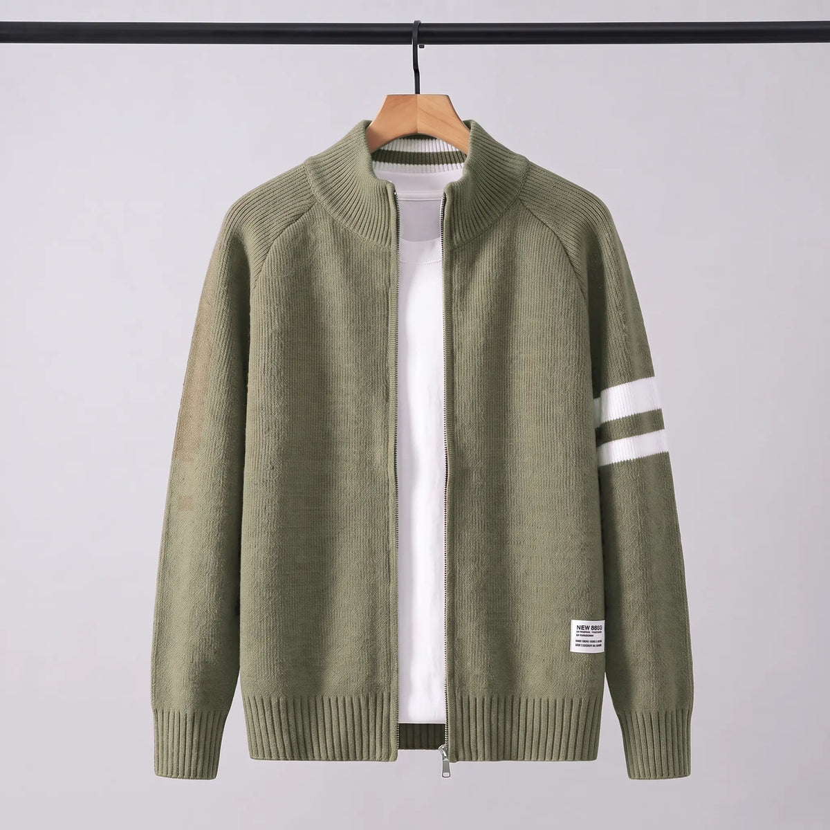 Raglan Zip Cardigan in green on a wooden hanger, men's knit full-zip cardigan with white sleeve stripes