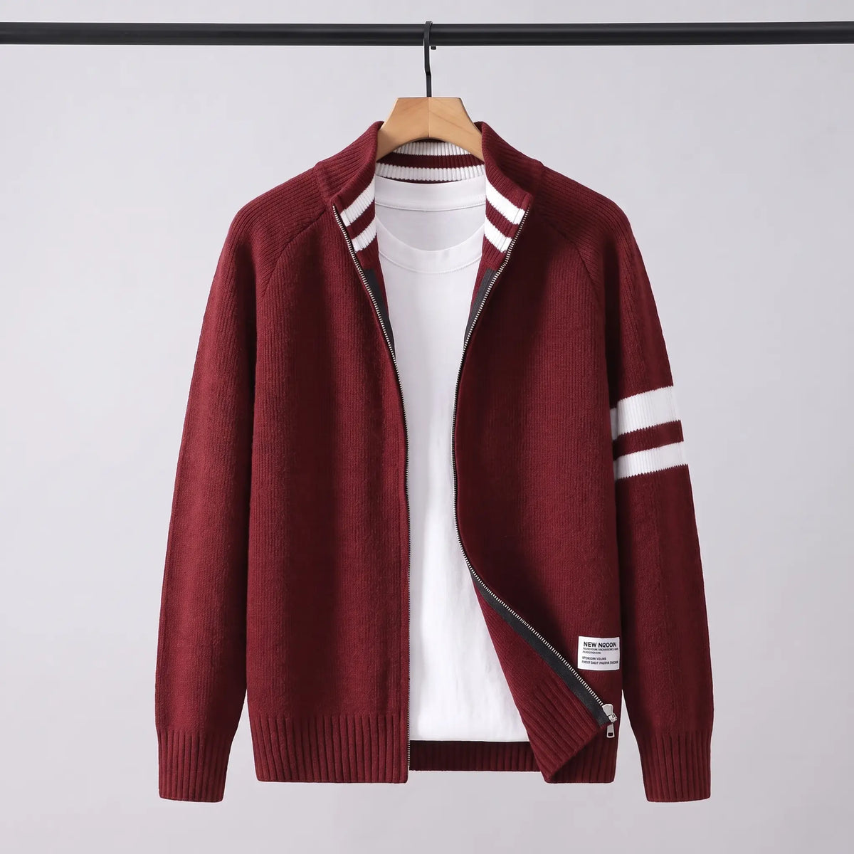 Raglan Zip Cardigan in red on a wooden hanger, men's knit full-zip cardigan with white sleeve stripes