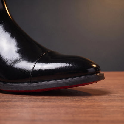 RED SOLE BOOTS black patent, close-up of cap toe and red sole edge
