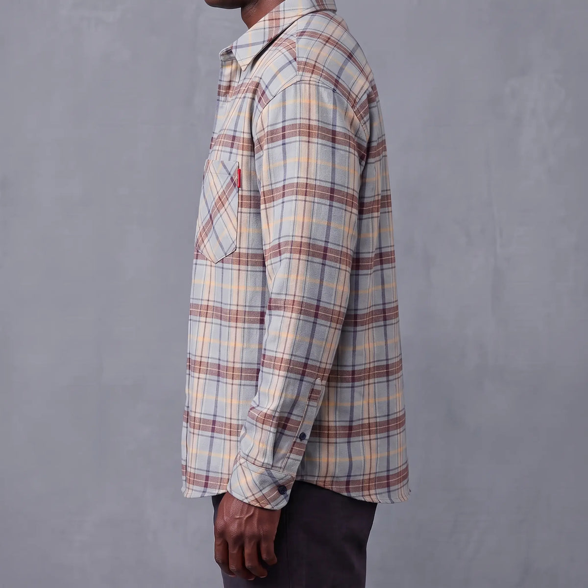 Side profile of the relaxed flannel shirt showing its loose cut