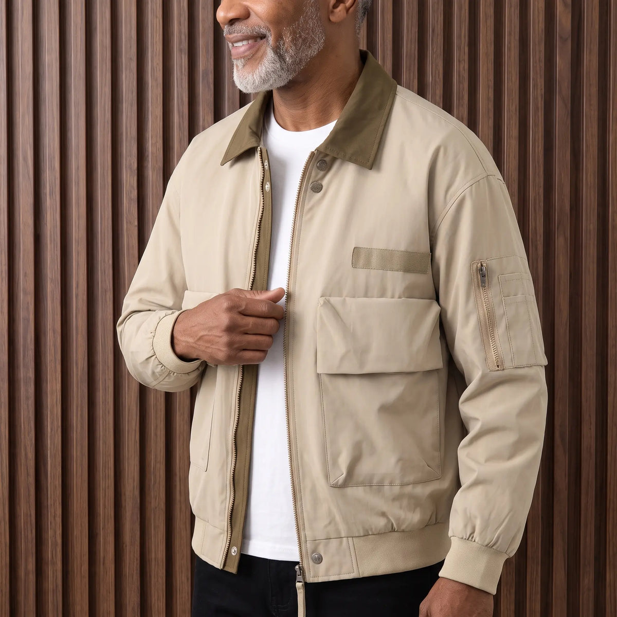 Man wearing the khaki retro pilot jacket over a white tee