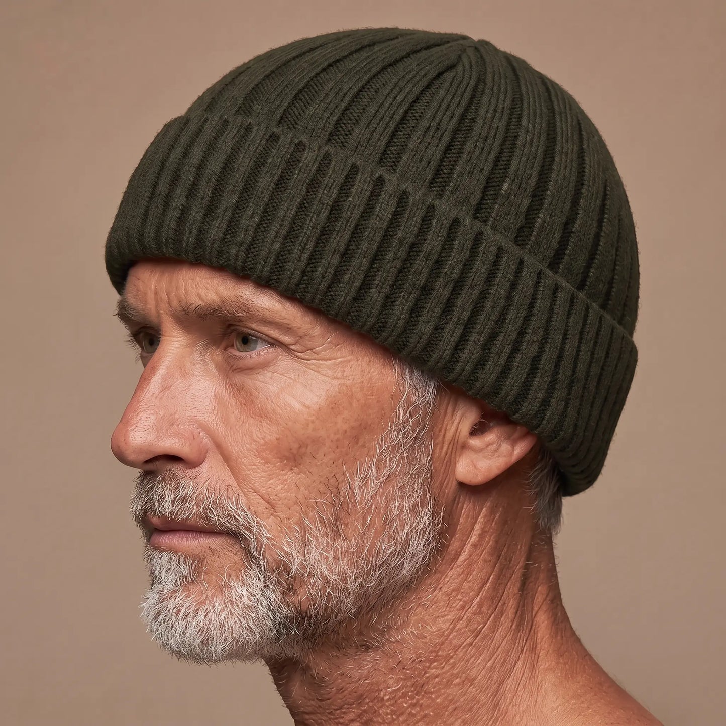 Ribbed docker beanie in green worn side profile by an older man