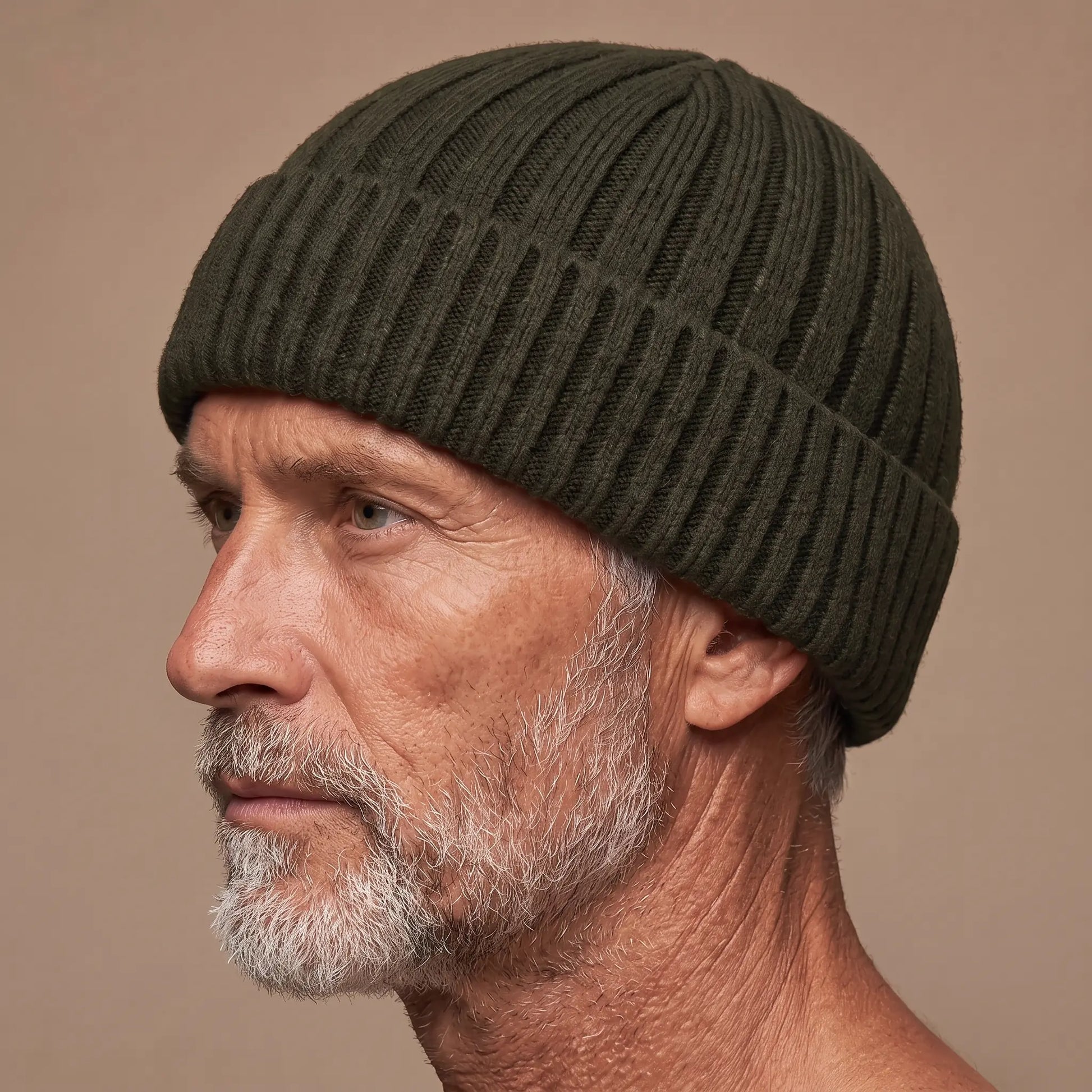 Ribbed docker beanie in green worn side profile by an older man