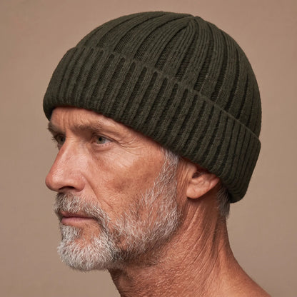 Ribbed docker beanie in green worn side profile by an older man