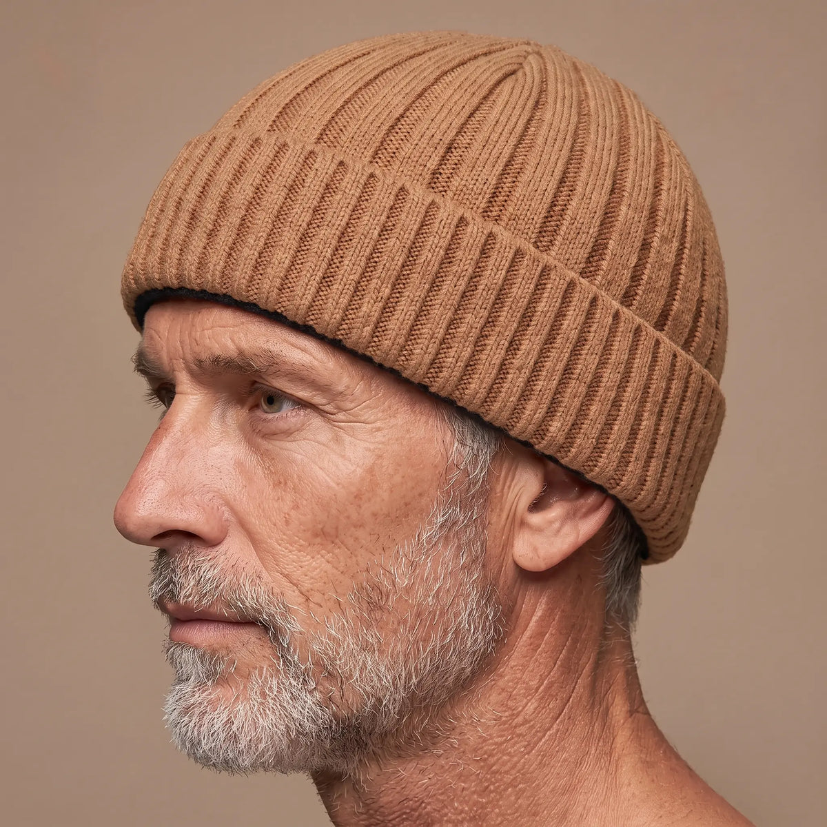 Ribbed docker beanie in khaki worn side profile by an older man