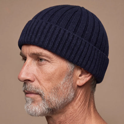 Ribbed docker beanie in navy worn side profile by an older man