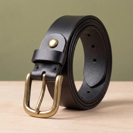 Rivet keeper belt in black cowhide with rounded brass pin buckle and brass stud on the loop