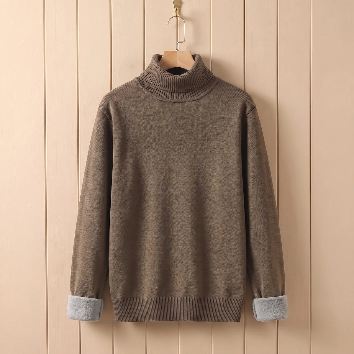 Men's khaki fleece lined roll neck sweater on a wooden hanger