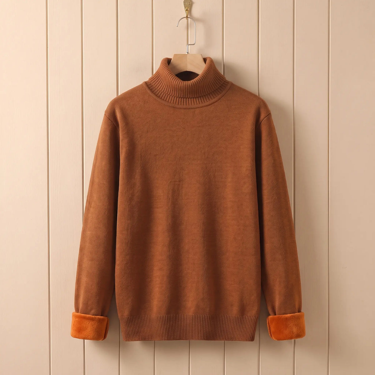 Men's orange fleece lined roll neck sweater on a wooden hanger