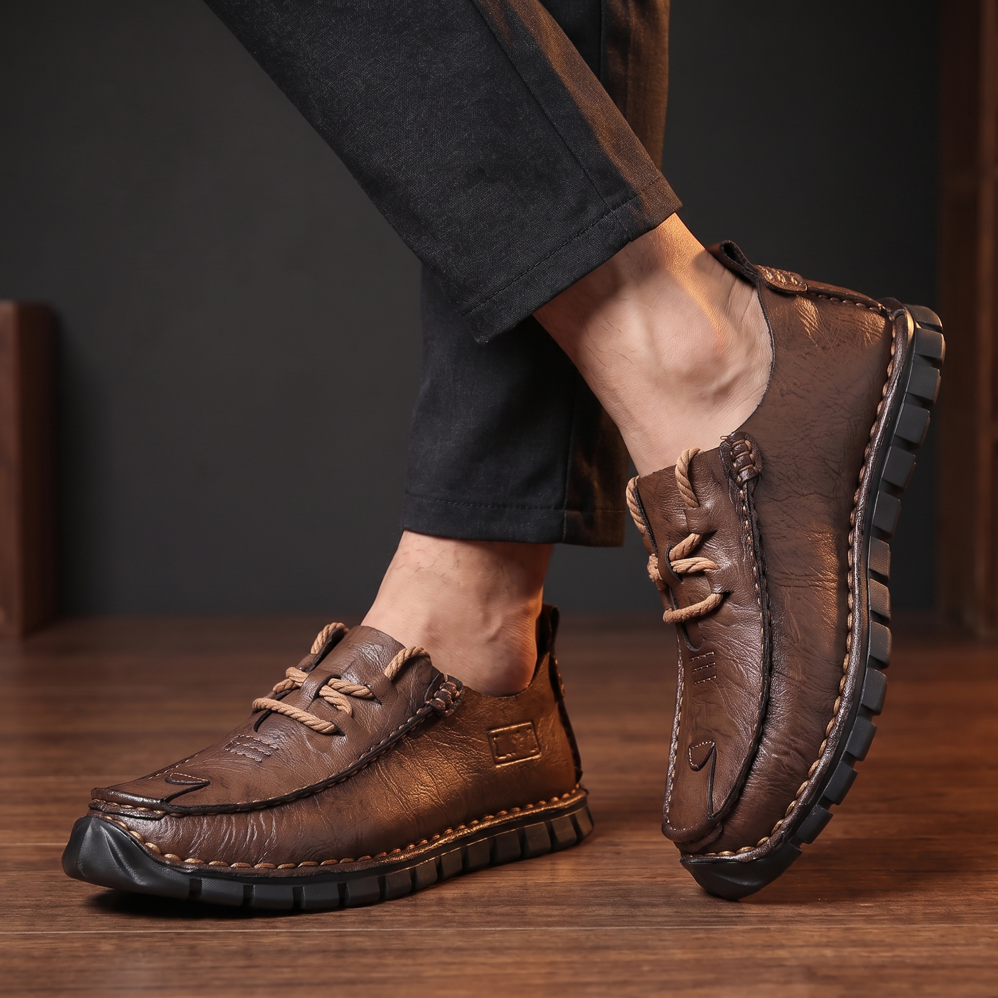Man standing with ankles crossed wearing the leather moccasins