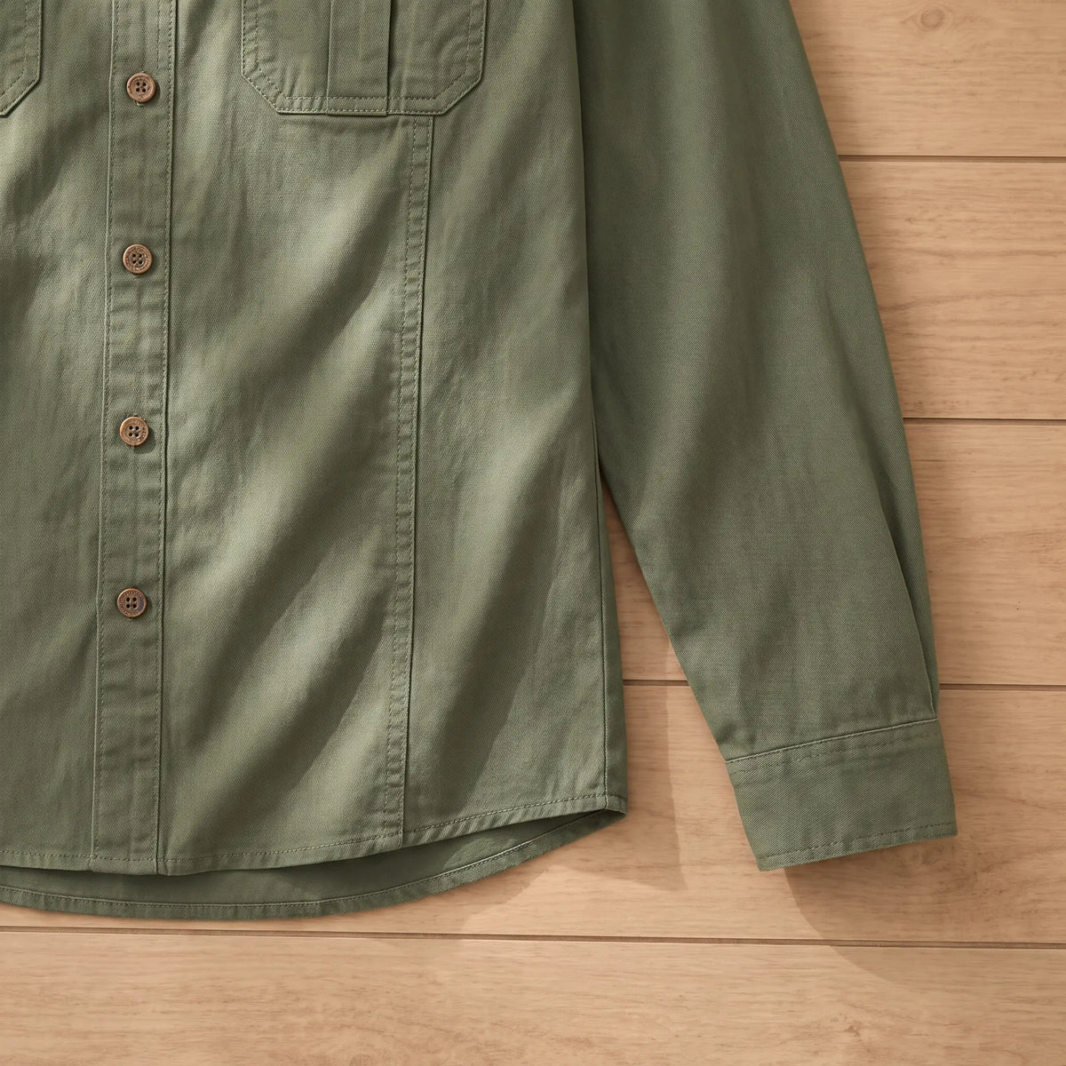 Buttoned cuff and curved hem detail