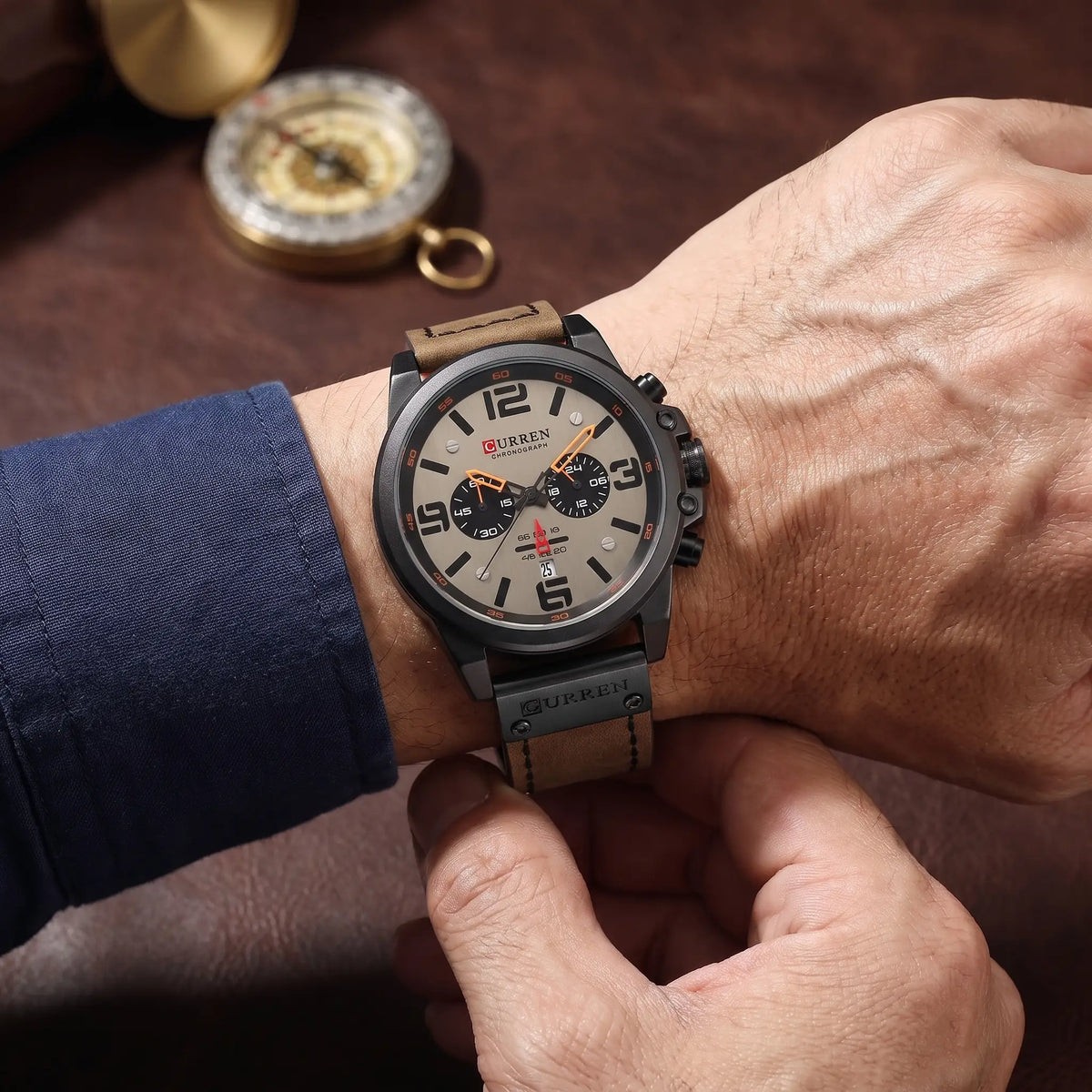 Man fastening a black and grey chronograph watch on his wrist