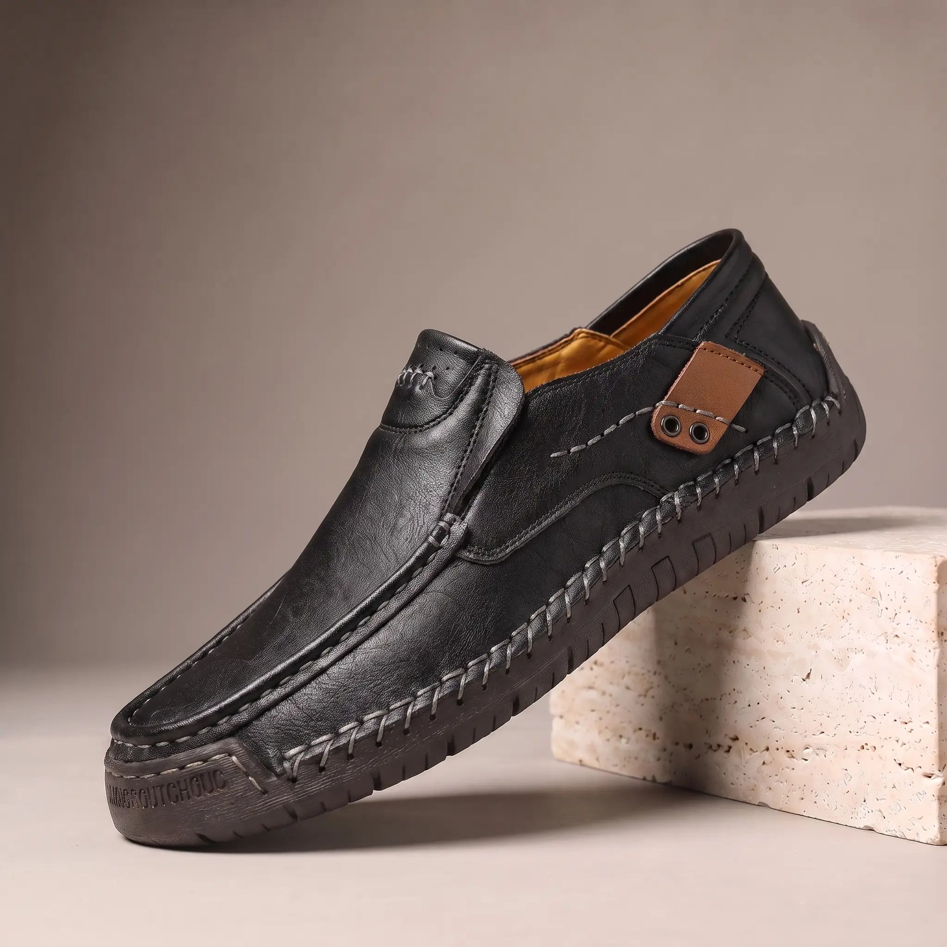 Black side tab leather loafers with hand stitched welt and rubber driving sole