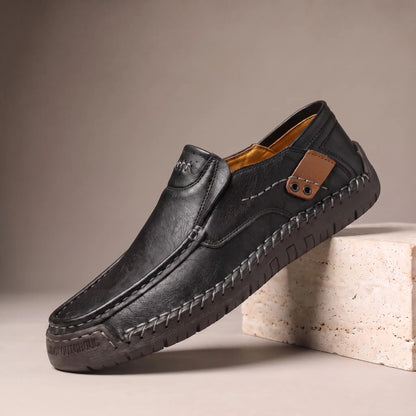 Black side tab leather loafers with hand stitched welt and rubber driving sole