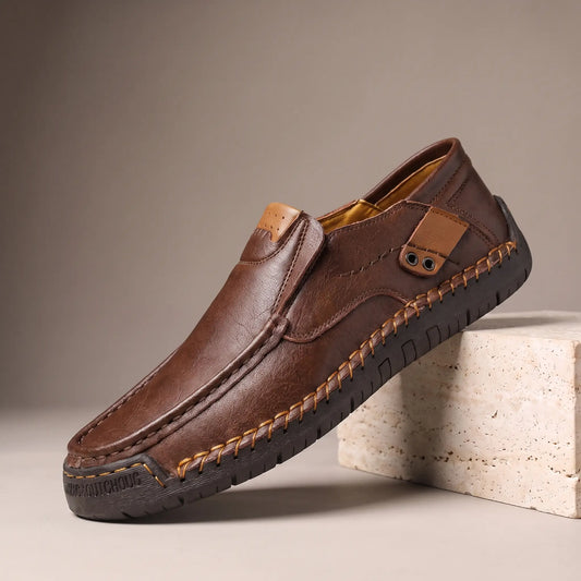 Dark brown side tab leather loafers with hand stitched welt and rubber driving sole