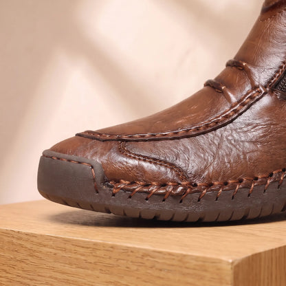 Close up of the SIDE ZIP BOOTS moc toe apron and hand stitching along the sole welt