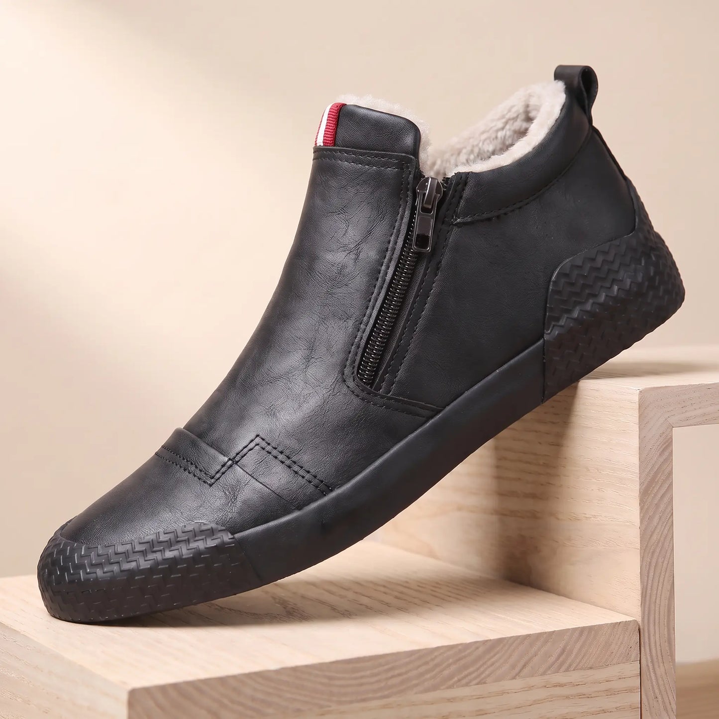Black plush lined side zip high top slip on shoes with rubber toe guard